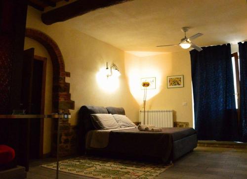 a bedroom with a bed with a teddy bear on it at B&B Il Castello in Castiglion Fibocchi