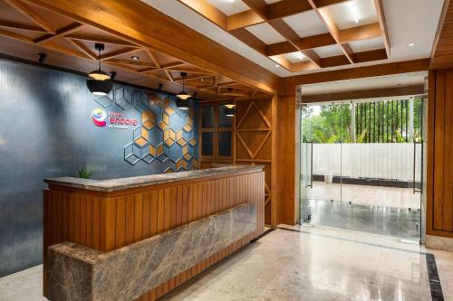 a lobby of a hotel with a reception counter at Ramada Encore by Wyndham Viramgam in Viramgām