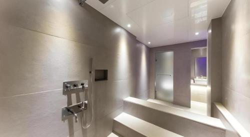a bathroom with a shower and a sink in it at Bobo Hotel Hongdae in Seoul