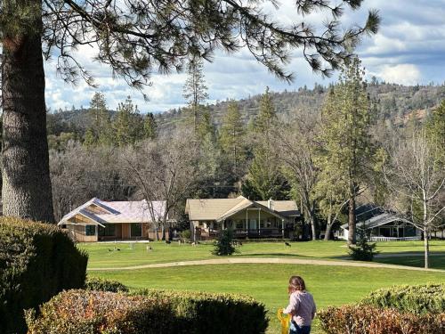 a woman walking in a park with a frisbee at On Golf Course, Family&Pet Friendly Yosemite Basecamp in Groveland