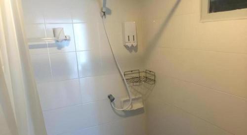 a bathroom with a shower with a hose at Betta Hostel in Ban Thai Don (1)