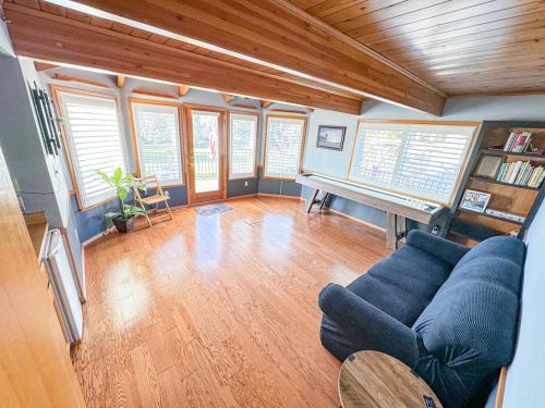 a living room with a blue couch and a piano at On Golf Course, Family&Pet Friendly Yosemite Basecamp in Groveland