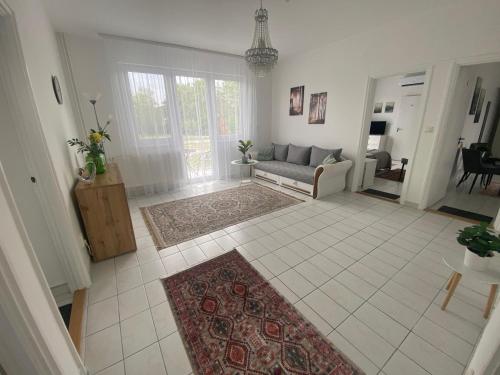 a living room with a couch and a rug at Lillybeth Lakeside in Keszthely