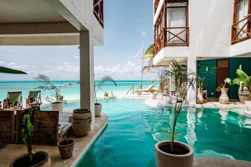 a swimming pool with a view of the ocean at Pili Pili Tropical Island in Jambiani