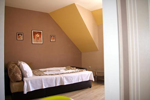 a bedroom with a bed with a yellow ceiling at Sea View Apartments in Sozopol