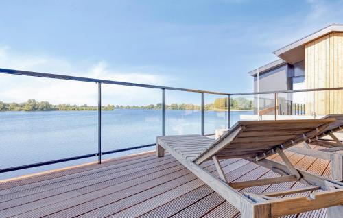 a wooden deck with a view of the water at Awesome Home In Kerkdriel With Wifi in Kerkdriel