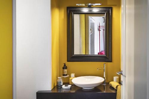 a bathroom with a white sink and a mirror at Villa Pieve San Giovanni in Lustignano