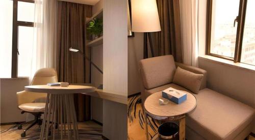 a living room with a chair and a table in a room at Clear Lake Hotel in Shanwei