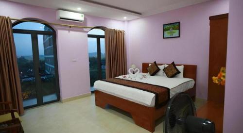 a bedroom with a bed and a large window at The Jade Dragon hotel in Hanoi
