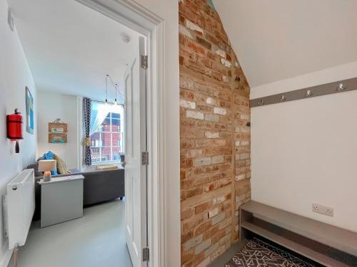 a room with a brick wall and a hallway at Apartment Two - Uk48496 in Gloucester