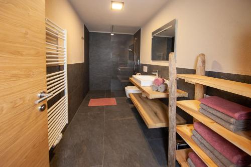 a bathroom with a shower and a sink and a toilet at Biohof Oberwerkstatt HAIDI in Obereggen
