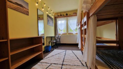 a room with two bunk beds and a window at Chata Šohajka - all inclusive & wellness in Pec pod Sněžkou