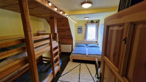 a room with two bunk beds and a window at Chata Šohajka - all inclusive & wellness in Pec pod Sněžkou
