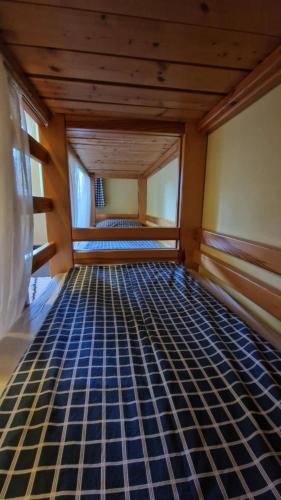 an empty room with a bed in a room at Chata Šohajka - all inclusive & wellness in Pec pod Sněžkou