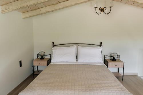 a bedroom with a large bed with two night stands at LOTOS Families Αpartments 1 in Konitsa