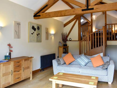 a living room with a couch and a table at Hilltoft Barn in Dockray