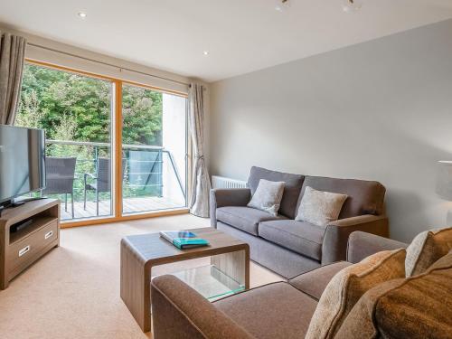 a living room with a couch and a tv at North Bay Sands Apartment 2- Uk2630 in Scarborough