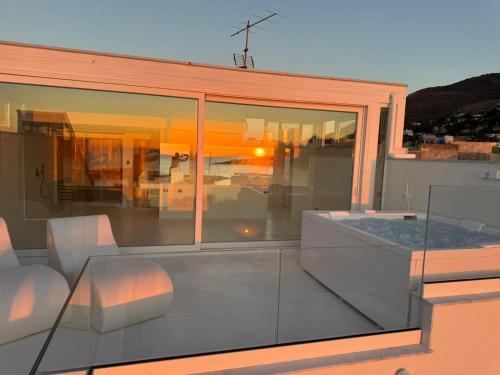 a balcony with a view of a house at Attico sul Mare - Suite & Spa in Palermo