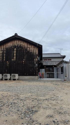 a large building with a fence in front of it at Rockstar Villa 江井浜STYLE in Awaji