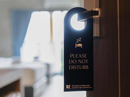 a sign on a door that says do not disturb at B2 Krabi Premier Hotel in Ao Nang Beach