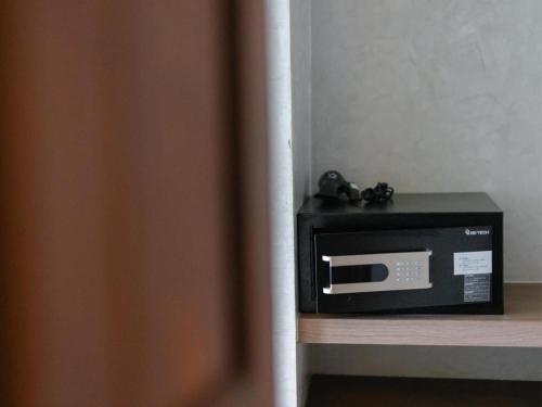 a microwave sitting on top of a counter at B2 Krabi Premier Hotel in Ao Nang Beach