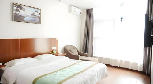 a bedroom with a large white bed and a chair at Vatica Shanghai Jiading District Anting Metro Station Moyu Road Hotel in Shanghai