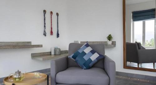a living room with a chair and skis on the wall at Boutique Kampot Hotel in Kampot