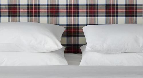two white pillows sitting on top of a bed at The George Montclair in Montclair