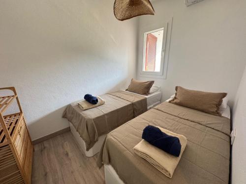 a room with two beds and a window at Apartamento Lulu in Son Bou