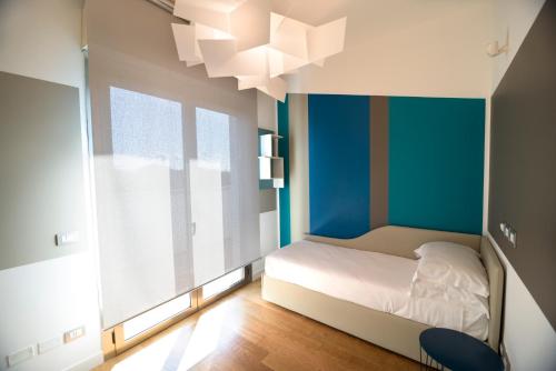 a bedroom with a bed and a large window at The One Hotel - Designed for Adults - Pet lovers in Riccione