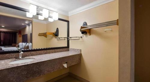 a hotel bathroom with a sink and a mirror at Best Western Hanford Inn in Hanford