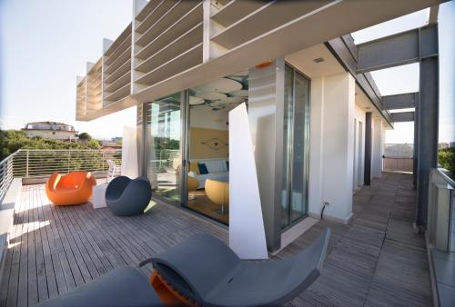 a balcony of a house with chairs on it at The One Hotel - Designed for Adults - Pet lovers in Riccione
