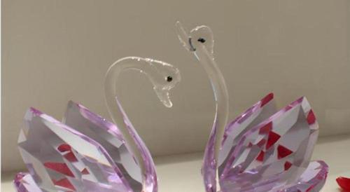 a glass swan vase sitting on top of a counter at Jiaxin Conifer Hotel Shunde in Shunde