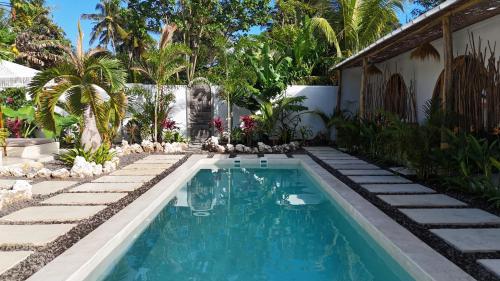 a swimming pool in the backyard of a house at Alma Nusa Penida in Nusa Penida