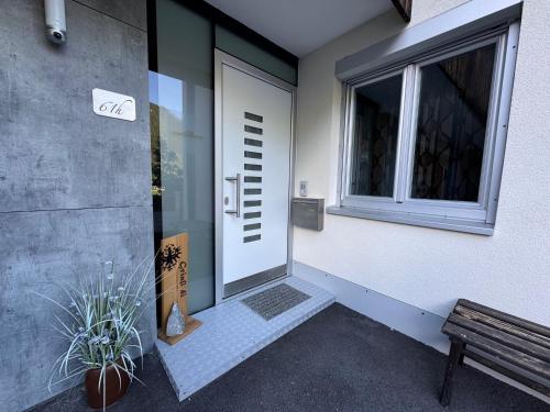 a door to a building with a bench and a window at Ferienhaus Sellraintal in Gries im Sellrain