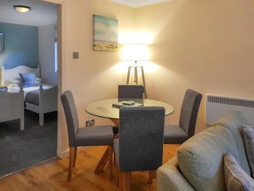 a living room with a table and a couch at Leven Lodge 2 - Uk46044 in Balloch