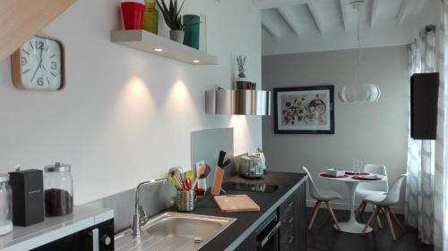 a kitchen with a sink and a counter top at Mansion Victorine in Honfleur