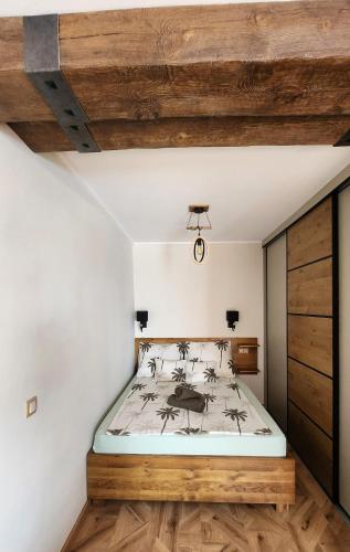 a bedroom with a bed and a wooden ceiling at Apartman CA34 in Villajoyosa