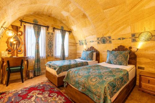 a bedroom with two beds in a wooden room at Walnut House in Goreme