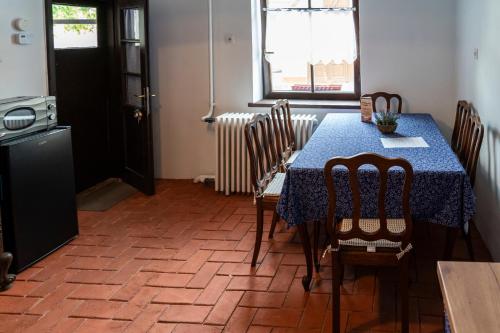 a dining room with a blue table and chairs at Patakparty Lak in Szilvásvárad