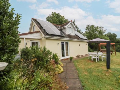 a house with solar panels on the roof at Hideaway in Great Torrington