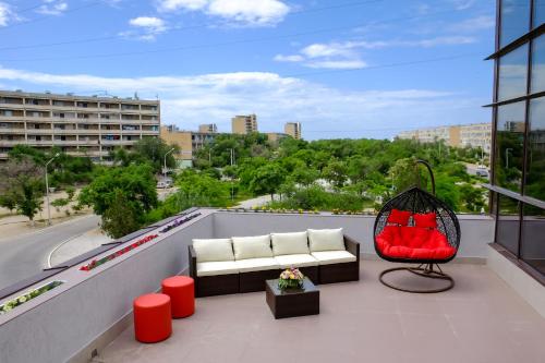 a balcony with a couch and a chair on a building at ZhanaOtel Hotel in Aktau