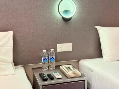 two bottles of water on a table in a hotel room at First Garden Hotel Managed By KR Cosmos Sdn Bhd in Kuantan
