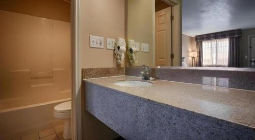 a bathroom with a sink and a toilet at Best Western Taylor Inn in Taylor