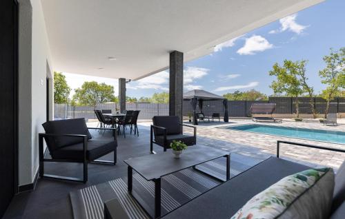 a living room with a couch and a table and a pool at Lovely Home In Imotski in Imotski