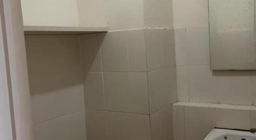 a white bathroom with a toilet and a cabinet at Bogor Valley Hotel in Bogor
