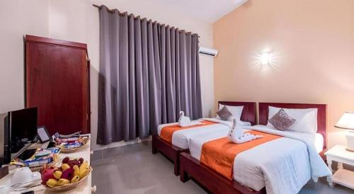 Postel nebo postele na pokoji v ubytování Lemongrass & Ginger Hotel