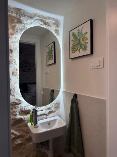 a bathroom with a sink and a mirror at The Hideaway - Kastel Novi in Kaštela