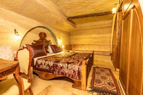 a bedroom with a bed and a table in a room at Walnut House in Goreme