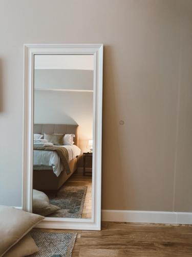a mirror in front of a bedroom with a bed at Stay Central in Ioannina
